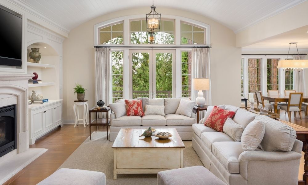 In a family room, two sofas and TV on top of fireplace