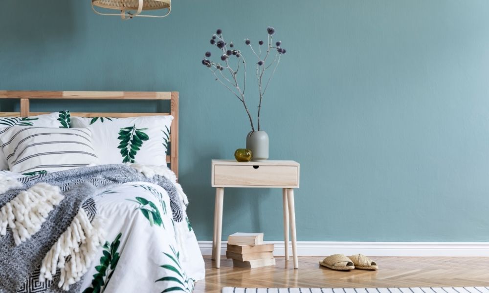 A bed with a leaves designed blanket